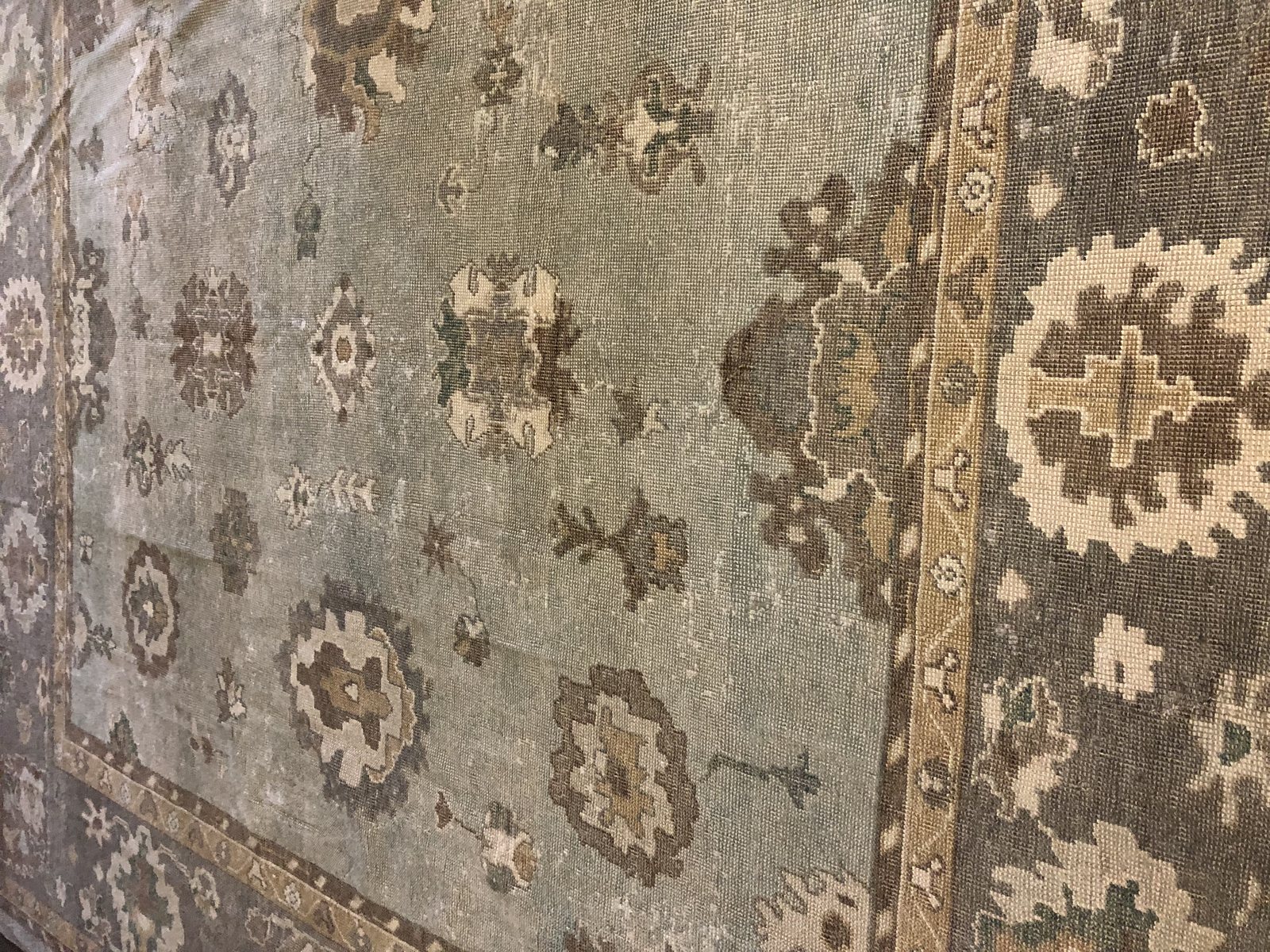 Antique Oushak rug with large-scale palmettes on a soft green field