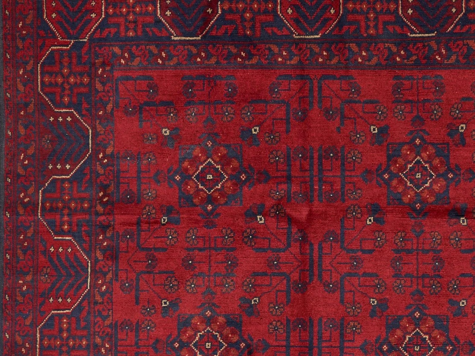 Afghan rug with rows of guls on a deep madder-red field