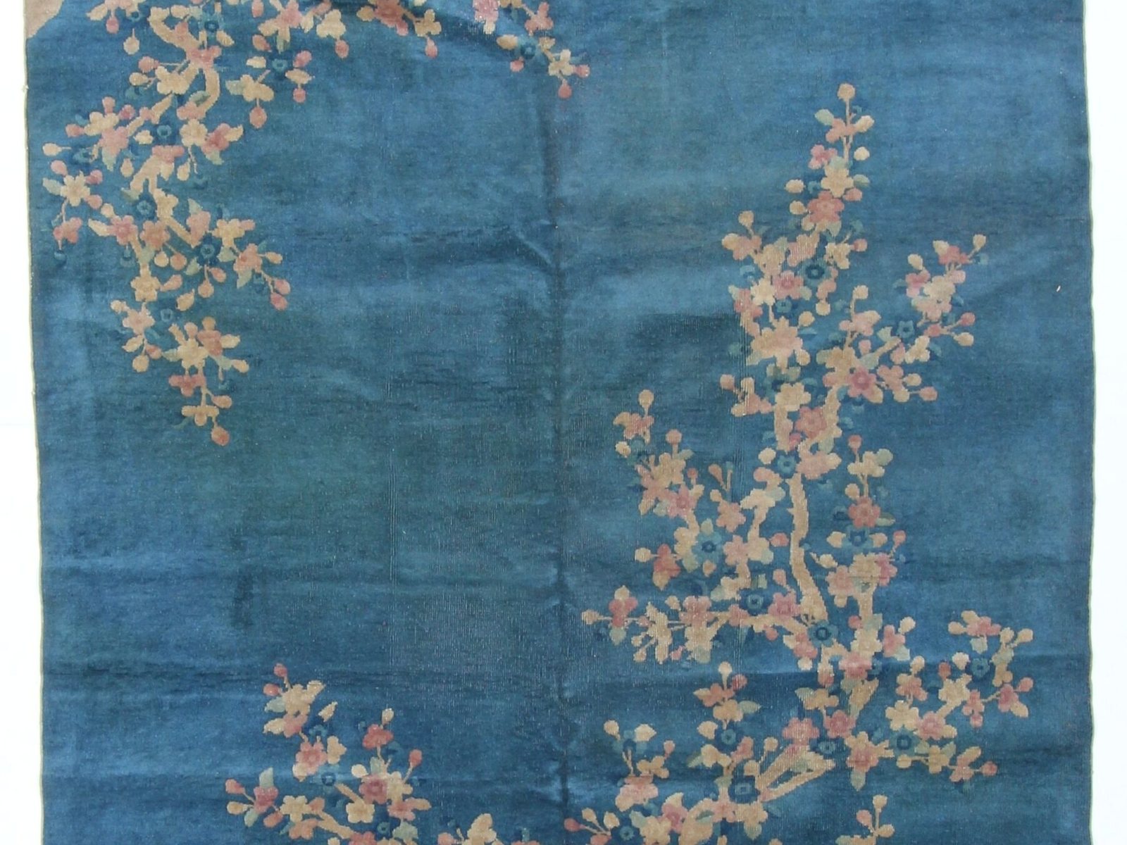 Chinese Art Deco rug with a blossoming branch on an open blue field